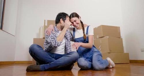 Young Couple Celebrates Moving Into New Home