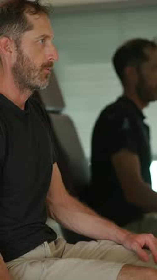 A Focused Man in a Contemporary Interior Setting Engaging in Thoughtful Contemplation