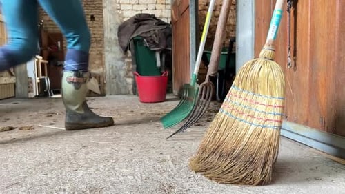 Farming Tools in Barn with Person Walking