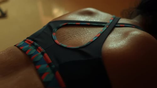 close up of a woman's sweaty back after a workout