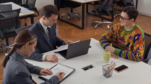 Dos gerentes de recursos humanos hacen preguntas a los candidatos durante una entrevista de trabajo en la oficina