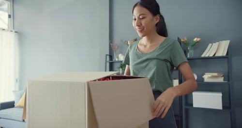 Woman Opening Shipping Box Indoors