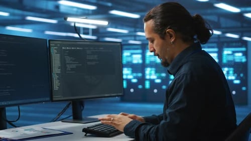 IT Engineer Typing on PC Keyboard Upgrading Servers