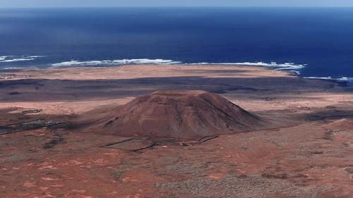 Aerial Drone Pan of Volcanic Cone and Coast Fuerteventura