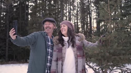 Of Couple Taking Selfie with Christmas Tree in Forest