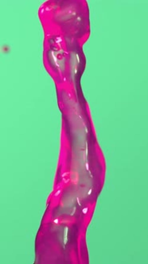 Pink Water Droplet Splash Against Light Green Background