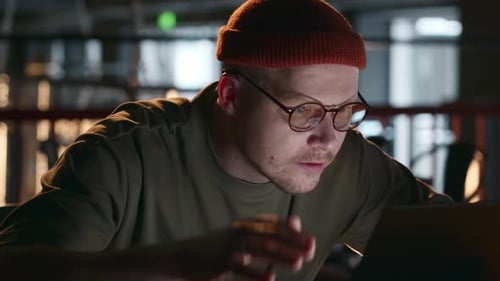 Young Adult Looking at Computer in Frustration