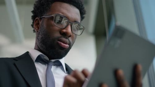 Happy African American Businessman in Office Smiling Using Digital Tablet Modern Technology Business