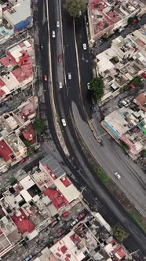 Straight-down, slow-motion aerial shot of a typical street in Ecatepec