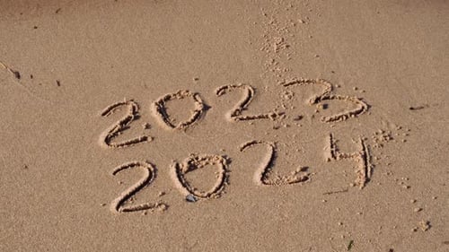 New Year Concept Text 2023 2024 Handwritten in Sand Surface Blue Ocean Wave Washing Away Numbers at