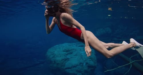 Sexy Freediver Woman with Diving Mask Swims Underwater in Transparent Blue Lake