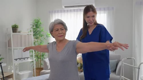 Senior Woman Doing Arm Exercises with Health Care Worker
