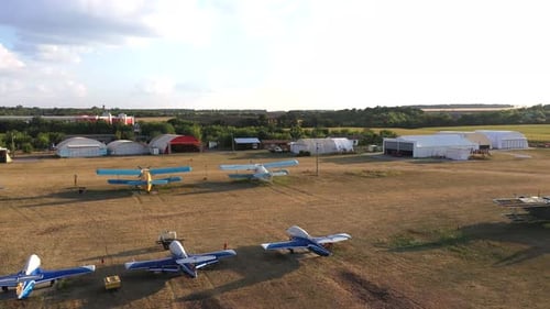 Aerial View to Rural Airport with Hangars and Different Mode of Airplanes
