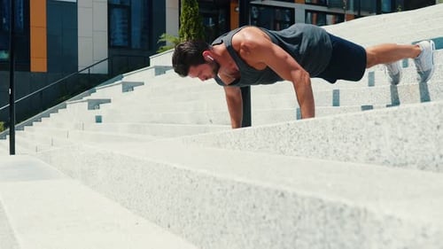 Man Doing Pushups on Urban Concrete Stairs