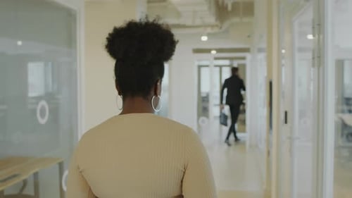 Black Businesswoman Walking through Corridor in Office