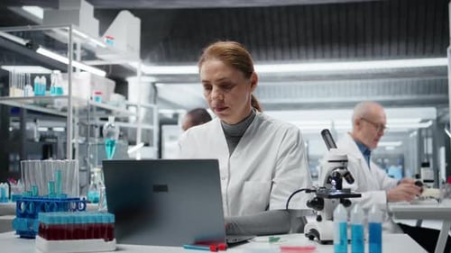 Scientist Working on Laptop in Modern Laboratory