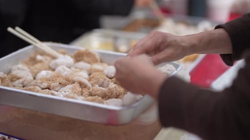 Adding ingredients to freshly made mochi