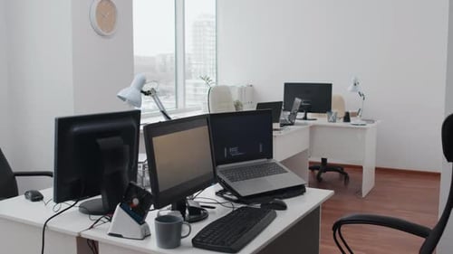 Modern Office Space with Computers and Desks
