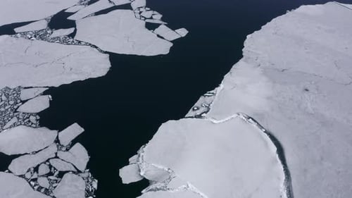 Flying Above Water Surface with Floating Ice Drone View