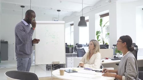 Multicultural People Collaborating on Working Strategy in Office