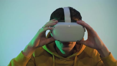 Young Adult Using Virtual Reality Headset Indoors