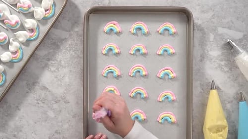 Flat Lay Step By Step Piping Meringue Mix Into Unicornshaped Pops on a Baking Sheet Lined with
