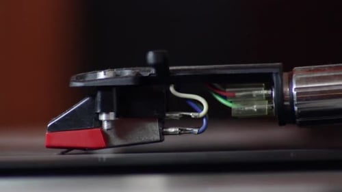 Vinyl lp record turntable tonearm spinning close up