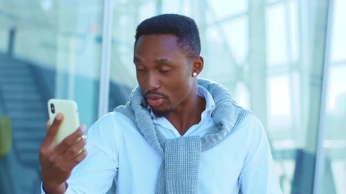 Nervous African American Man Use Smartphone for Video Call Speaking Stand Outside Near Airport