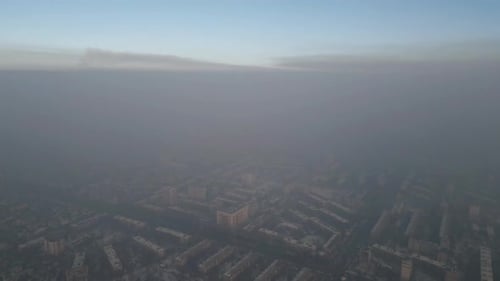 Aerial view of polluted city covered with smog