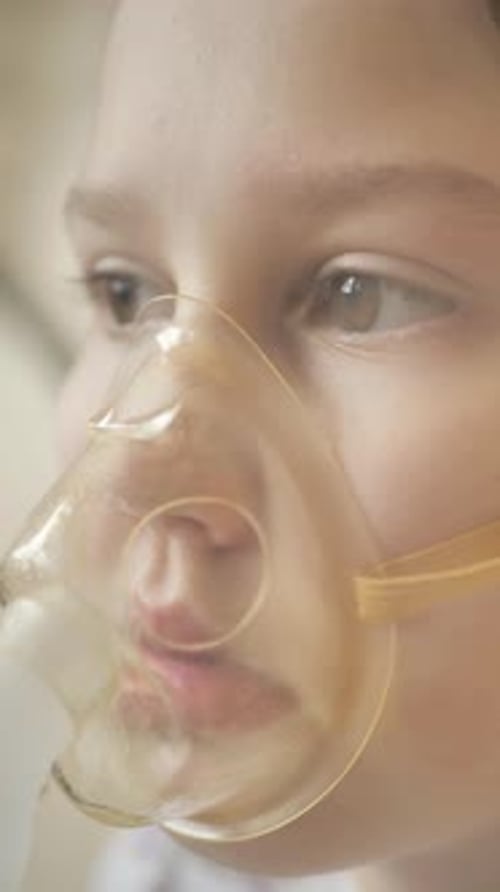 Child Wearing Oxygen Mask in Close Up Shot
