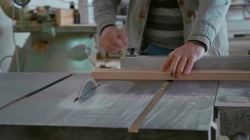 Circular saw cutting the wooden plank close up video.