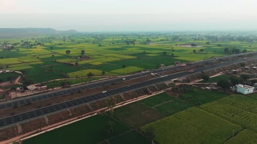 Aerial view of highway amidst fields, India.