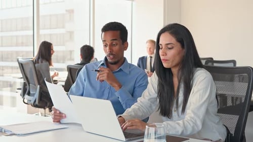 Coworkers Collaborating on Project in Modern Workplace
