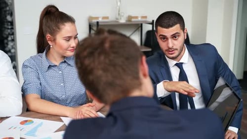 Diverse Team Discussing Business Strategy in Modern Office