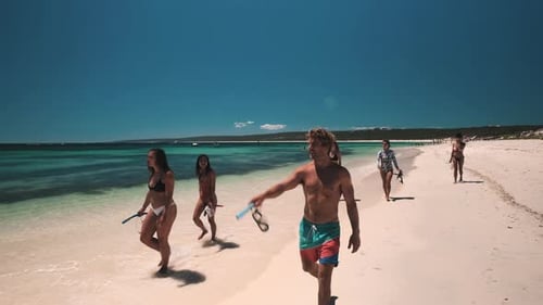 Group of young teenagers walking on sandy beach at hamelin bay searching for dive spot