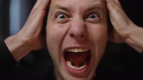 Man Expressing Rage and Frustration with Open Mouth