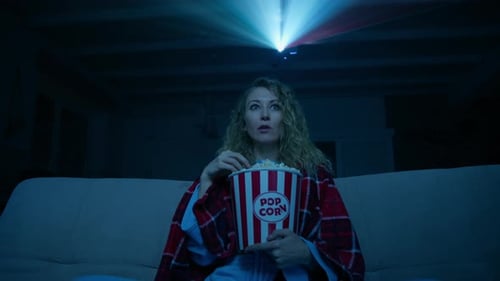 Woman Watching Movie at Home with Projector