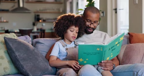 Loving Father Reading a Book with his Child