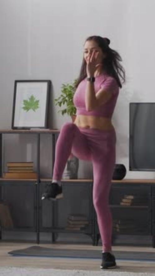 Woman doing warm up exercises at home