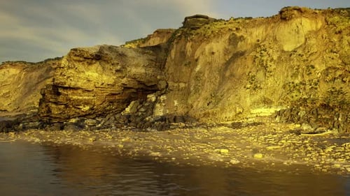 Shallow Tide Pools Reflecting Sky Amidst Rocky Coastal Landscape