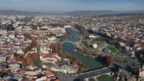 Aerial view of Tbilisi city central park and Bridge of Peace. Beautiful cityscape of old Tbilisi
