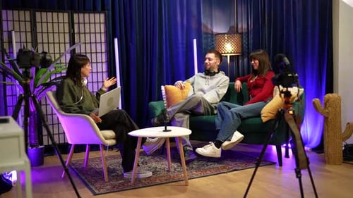 Three Young Adults Talking on a Couch
