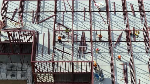 Industrial Construction Site with Workers Assembling Metal Frame Building Development of Residential