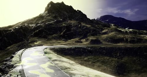 Mountain Road Winding Through Rugged Terrain Under a Bright Sky