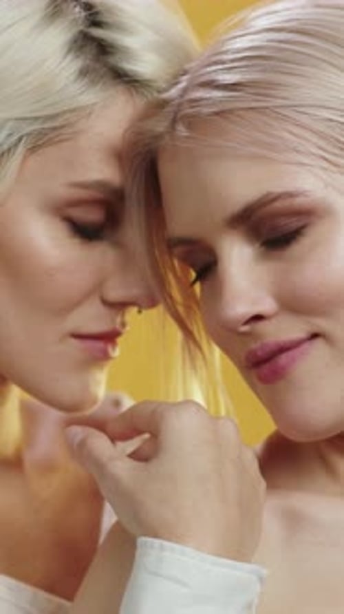 Two Blonde Women Touching in Intimate Fashion Pose