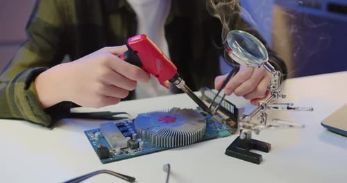 Soldering Iron Repairing Computer Circuit Board Close Up