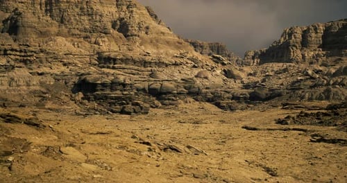 Rocky Desert Landscape with Rugged Formations Under a Moody Sky