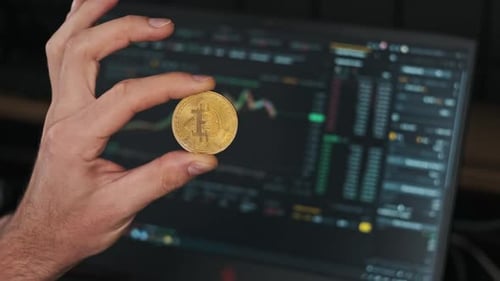 Hand Holding Bitcoin with Stock Market Data