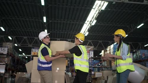Blue collar workers are working at warehouse.