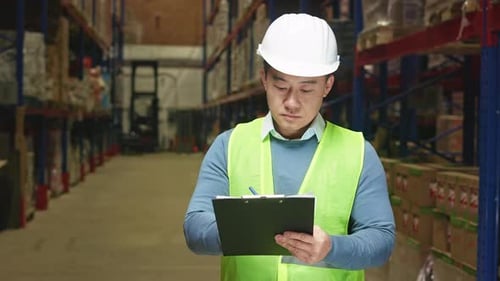 Supervisor Doing Stocktaking of Products at Warehouse